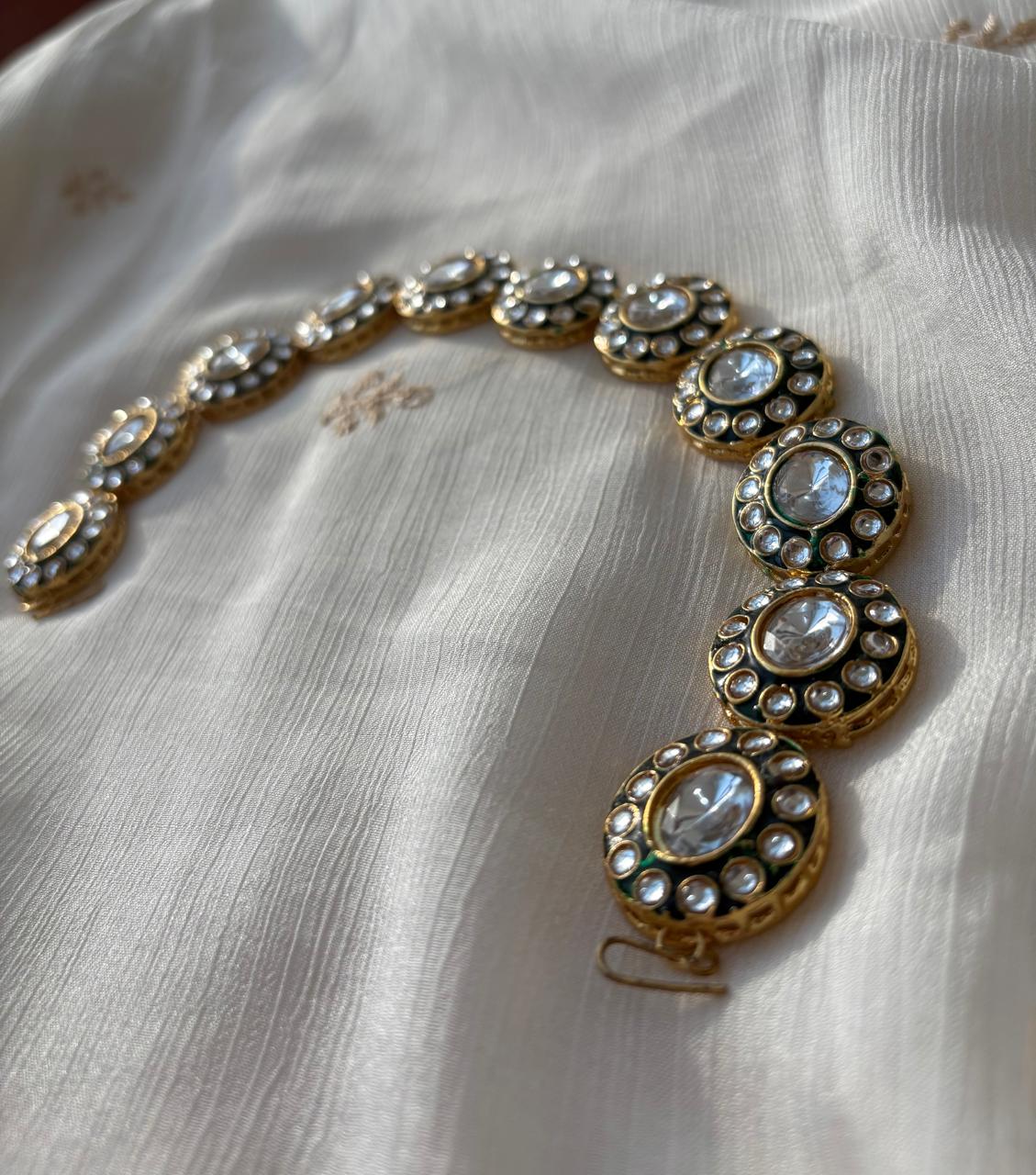 Sheesh phool (hair accessory)with pachi kundans and green enamel.