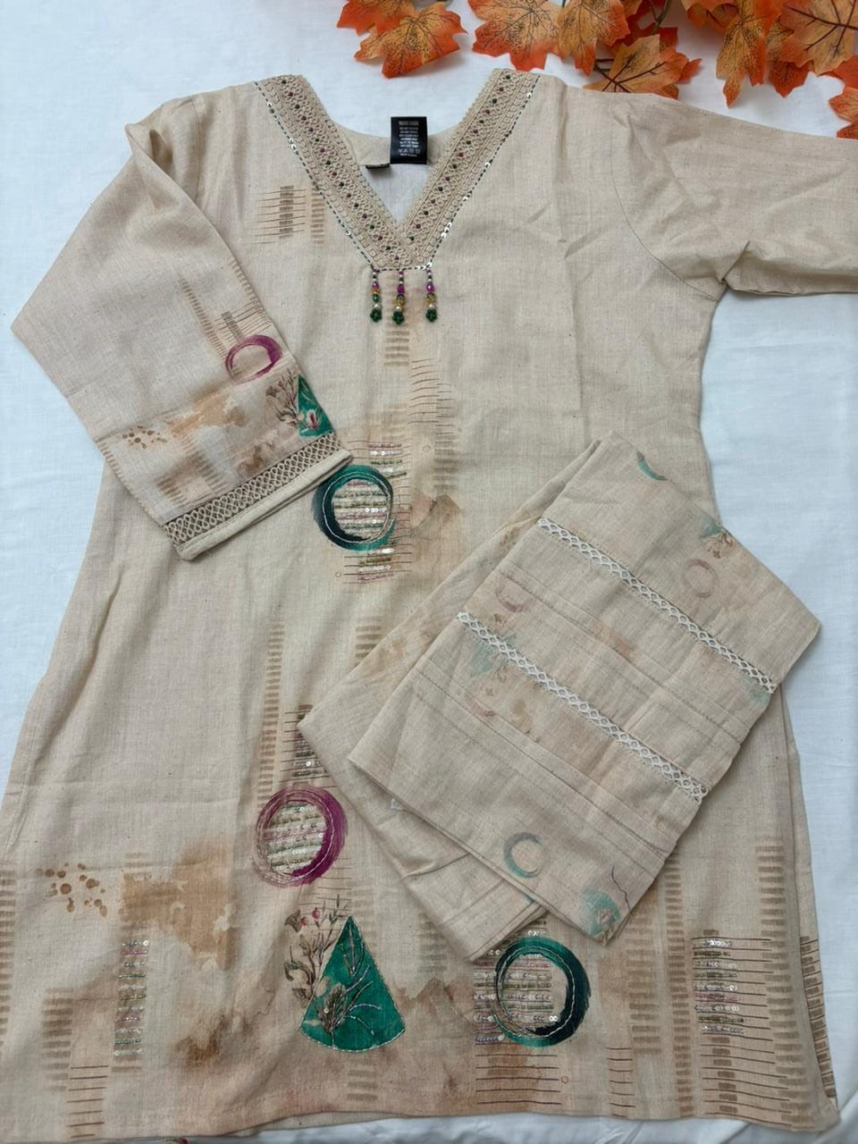 Minimalist boho co-ord set in light beige with thread detailing .