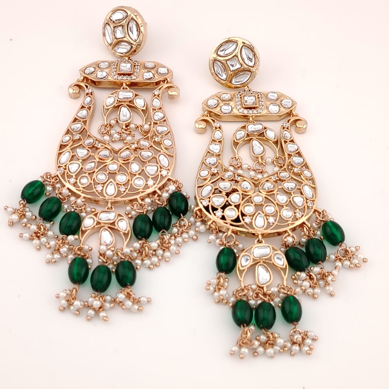 Big basket shaped chand bali with kundans, green awaze and pearls.