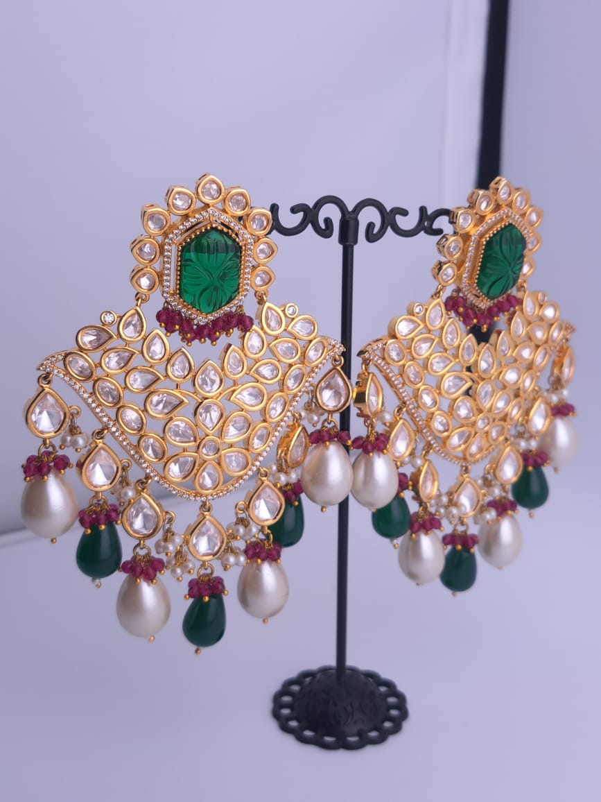 Bridal kundan earrings with carved green stones and dual drop hangings in pearls and emerald.