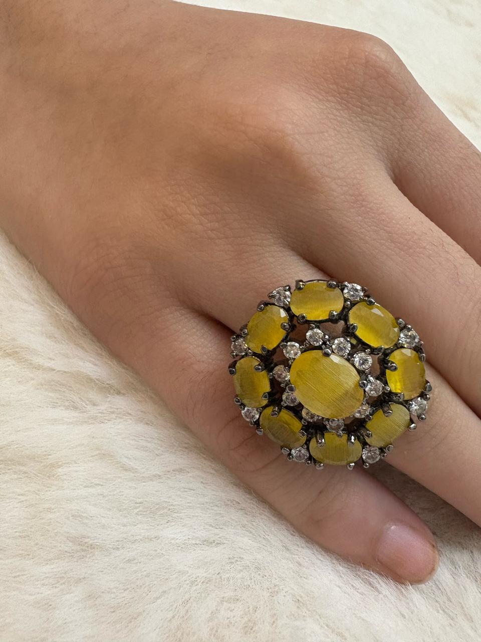 German silver oxidized finger ring with mustard and white zircons.