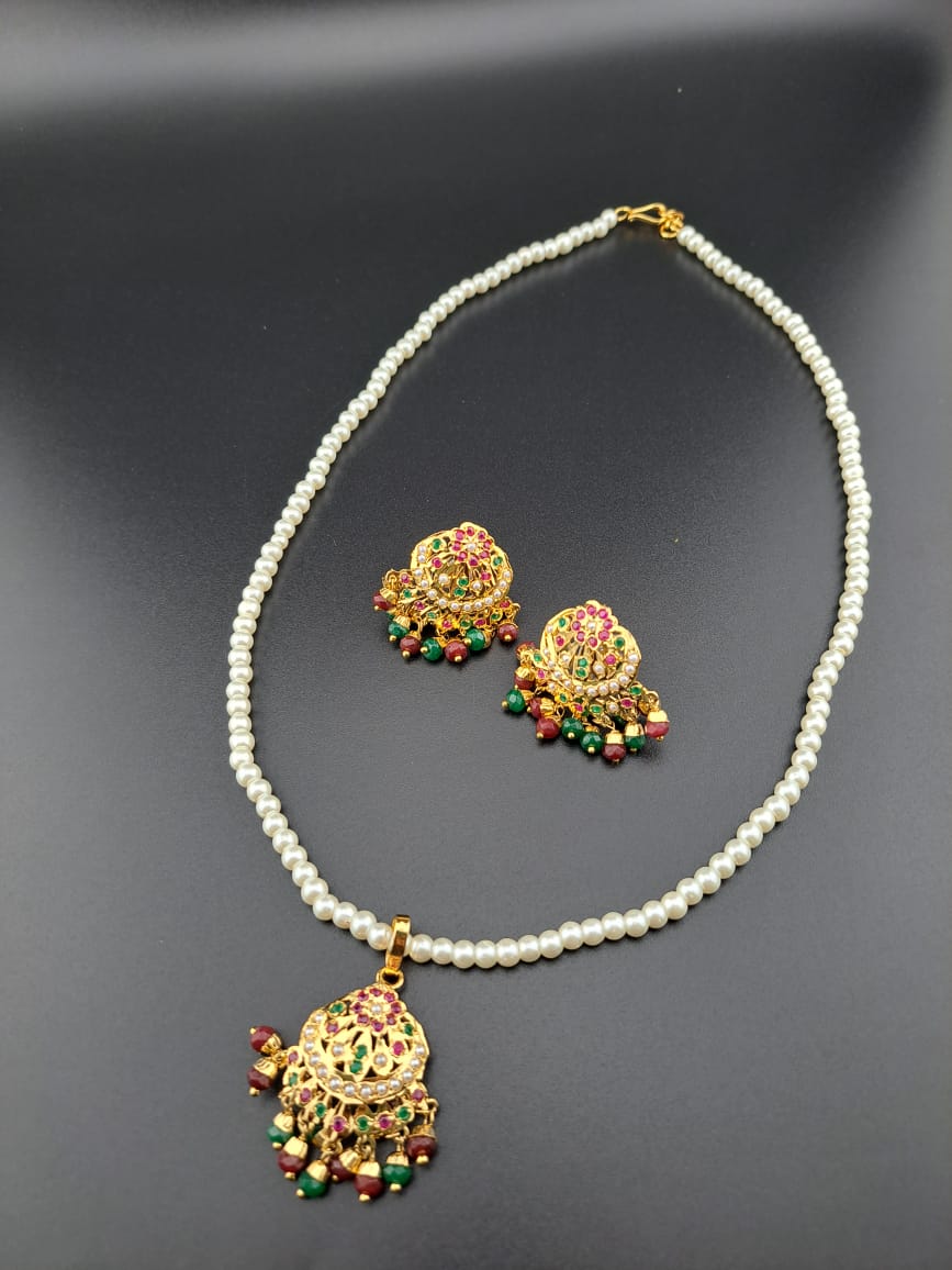 Hyderabadi pearl jadau necklace set in ruby and emerald.