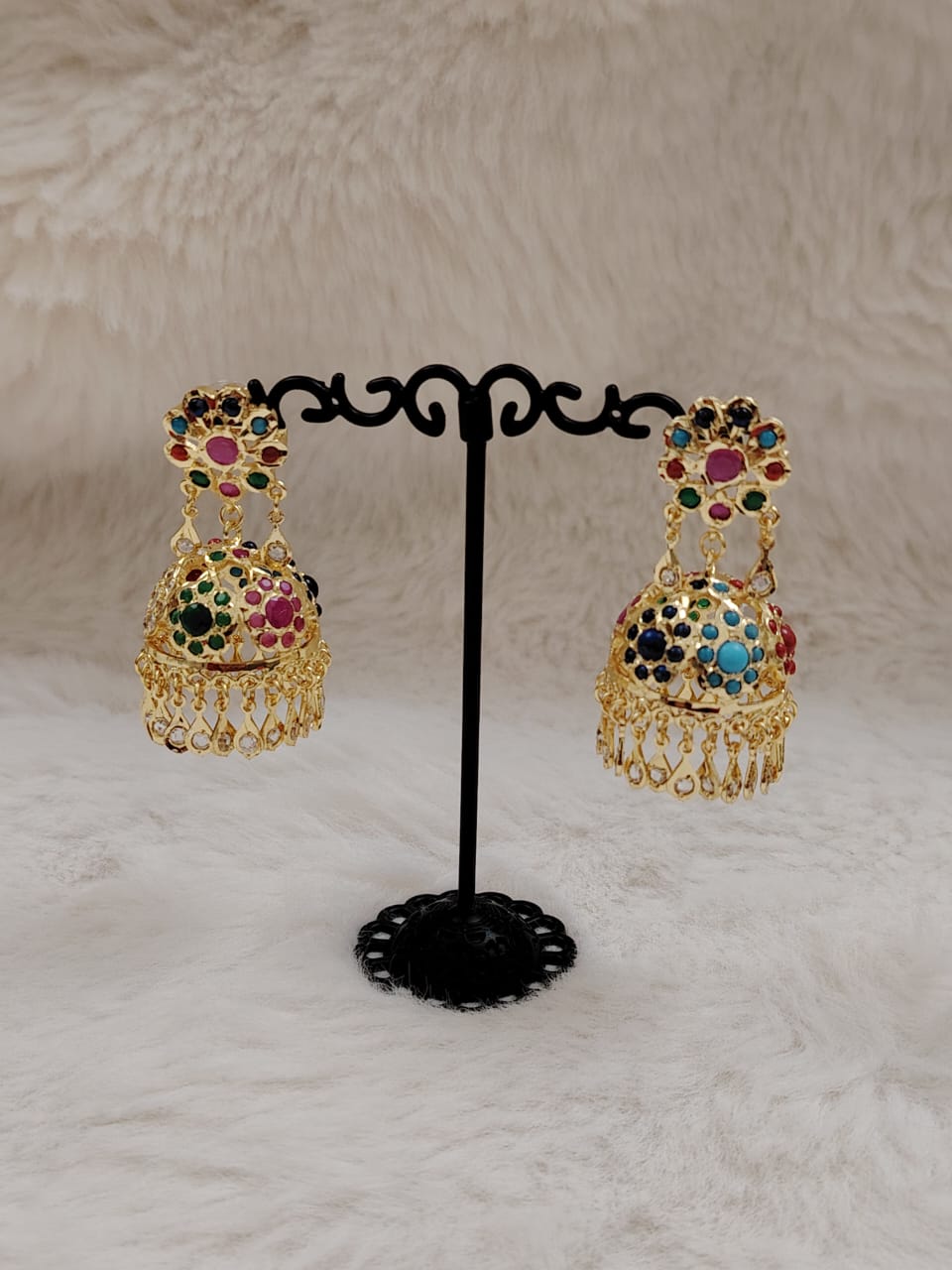 Gold jhumka with navratan(multicolor) stones.