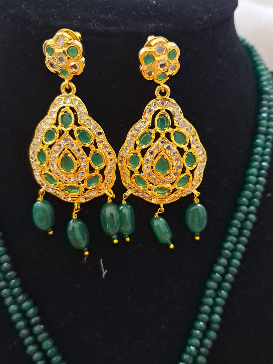 Hyderabadi pure onyx beads set with polki and emerald stones.