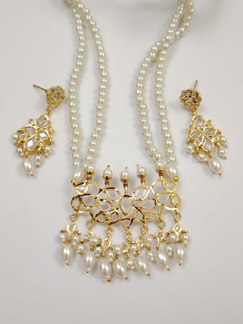 Hyderabadi tirmani pearl set with white stones.