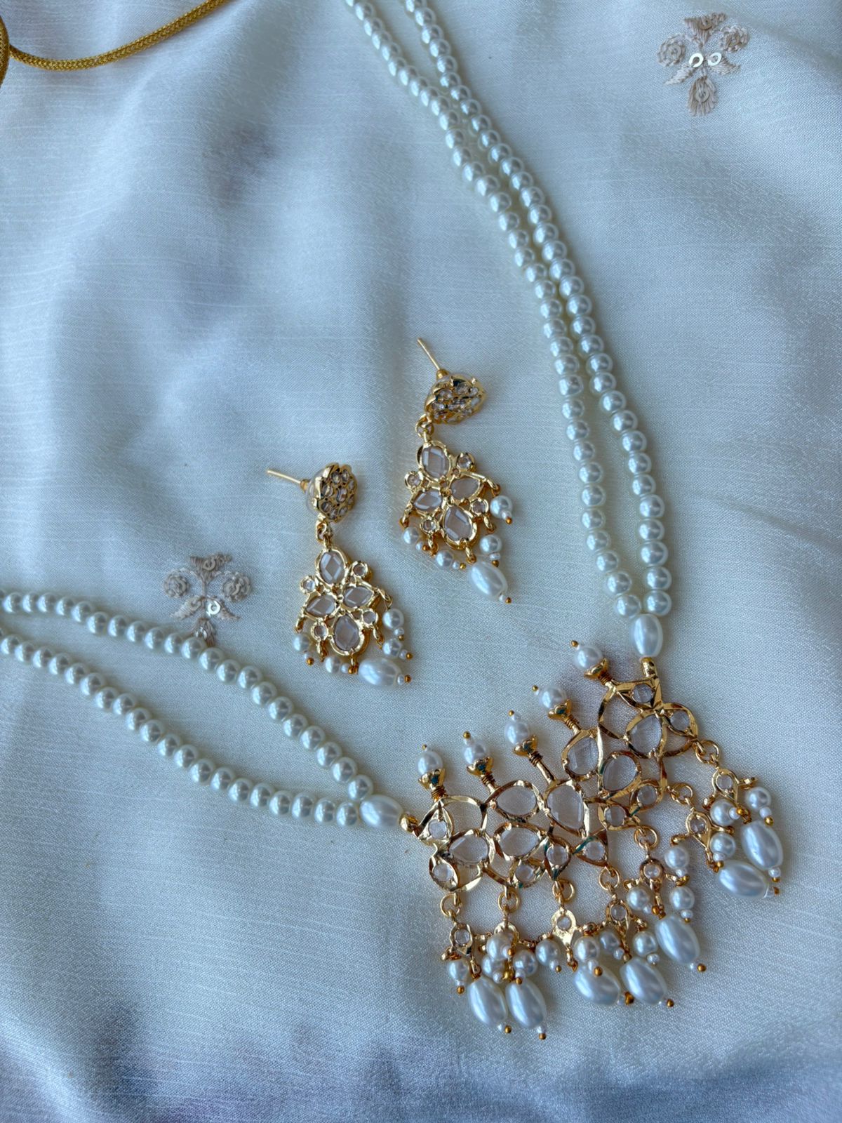 Hyderabadi tirmani pearl set with white stones.