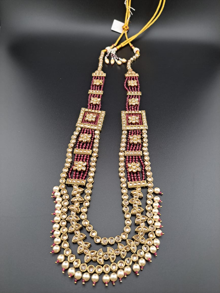 Long multi-layered set with red hydrobeads, reverse polki and tika.