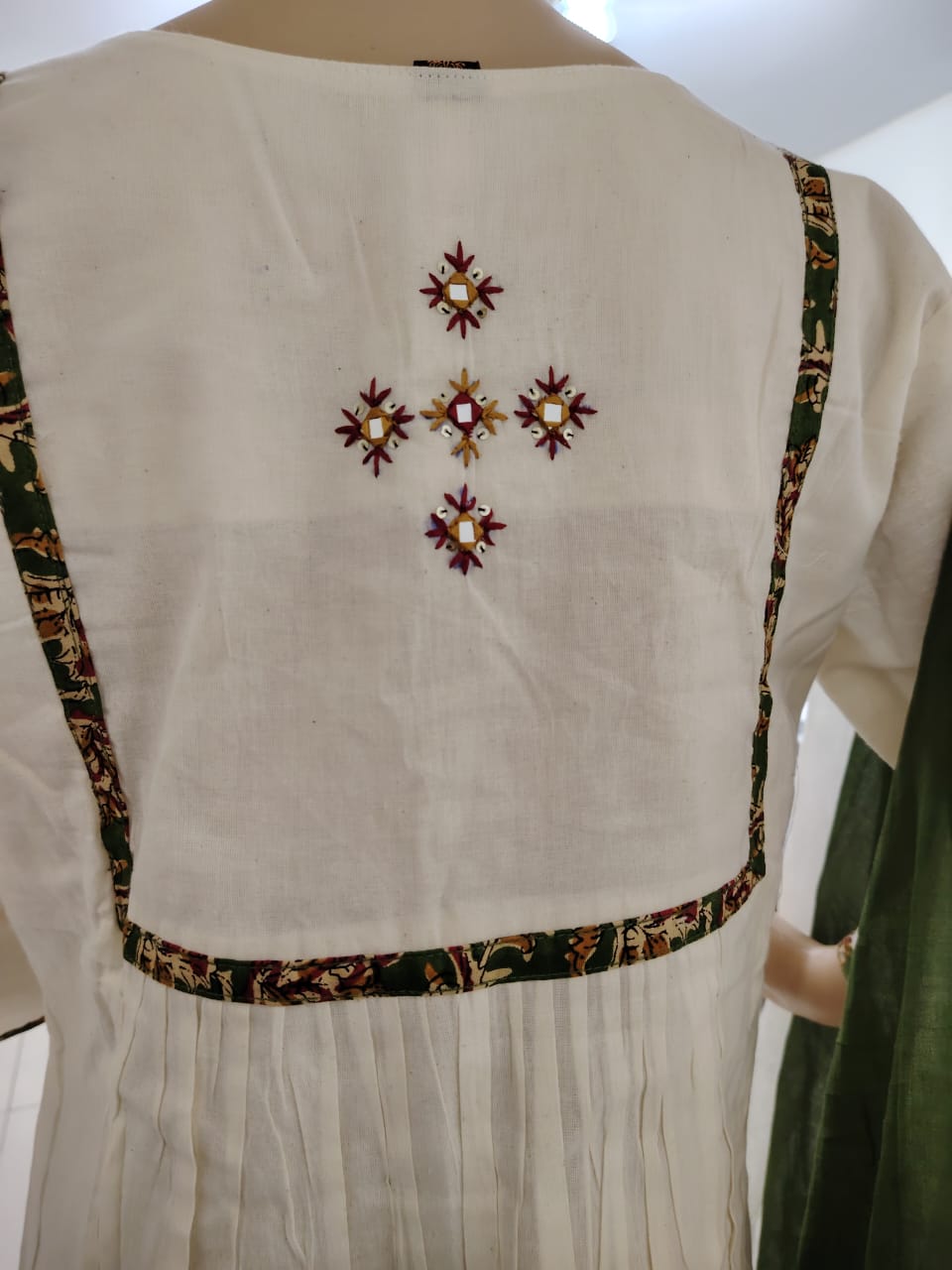 Offwhite kora cotton kurta paired with ajrakh palazzo and mul cotton dyed aplique dupatta.