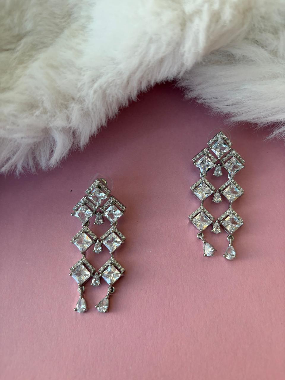 Silver danglers with american diamonds and cubic zirconia.