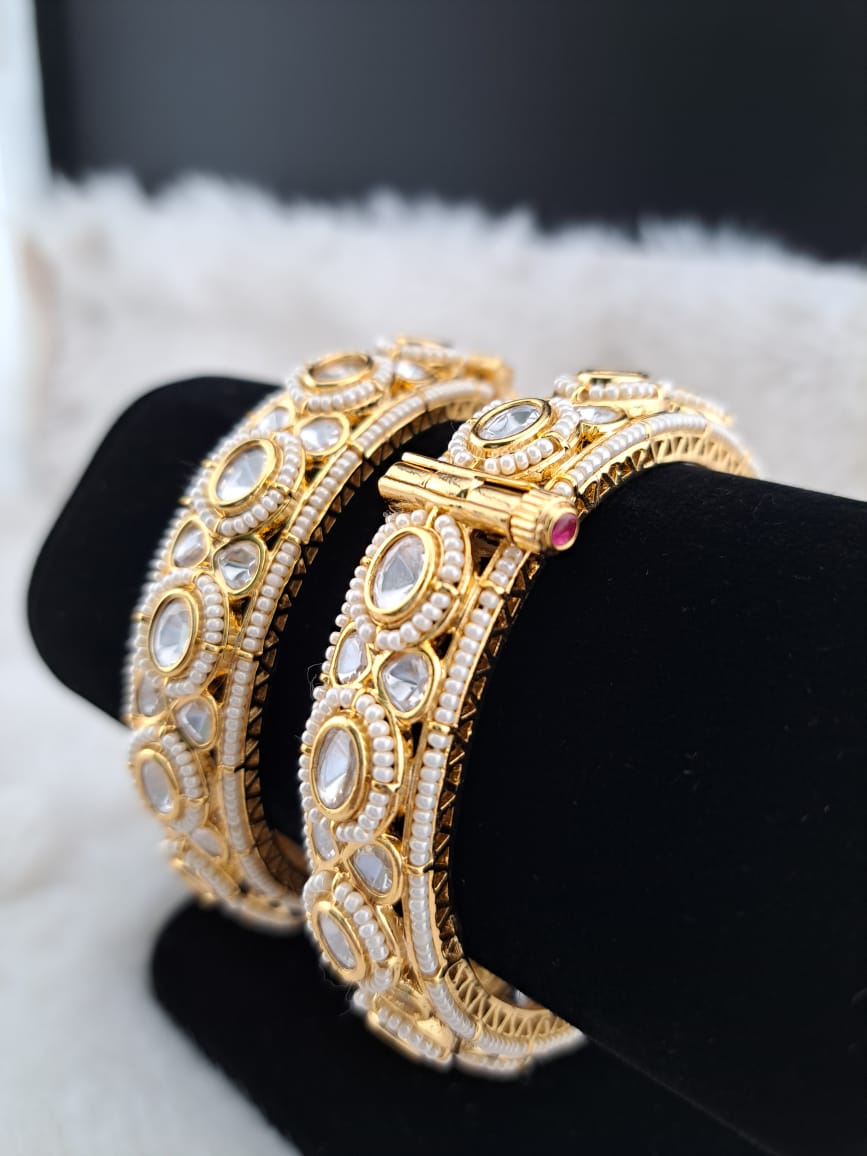 Kundan bangles with mini pearls.