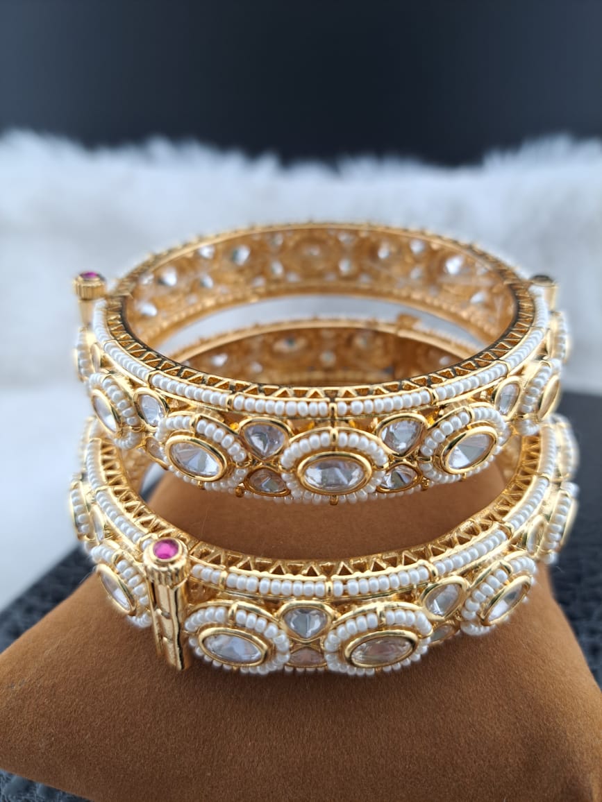 Kundan bangles with mini pearls.