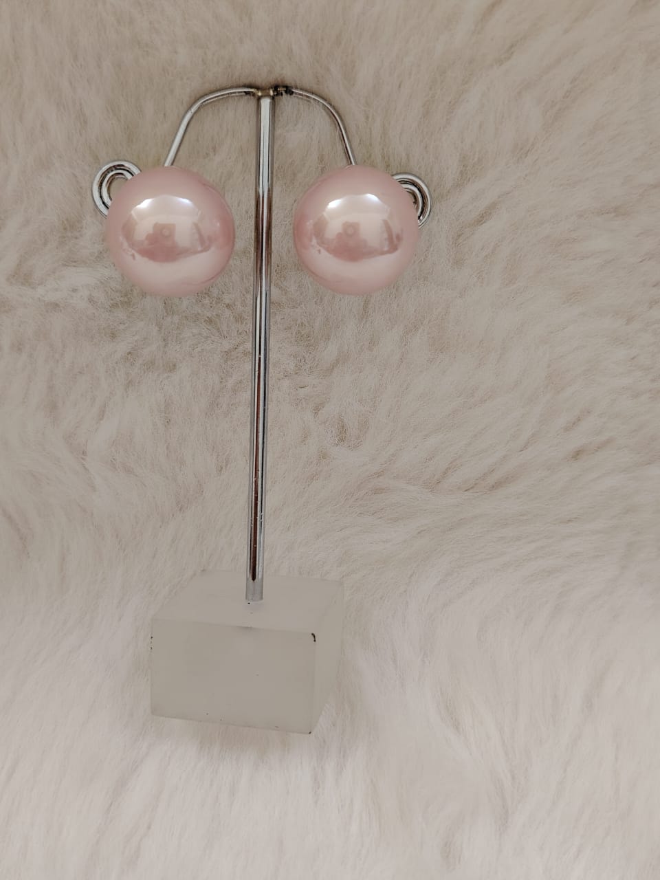 Oversized pearl studs in pink