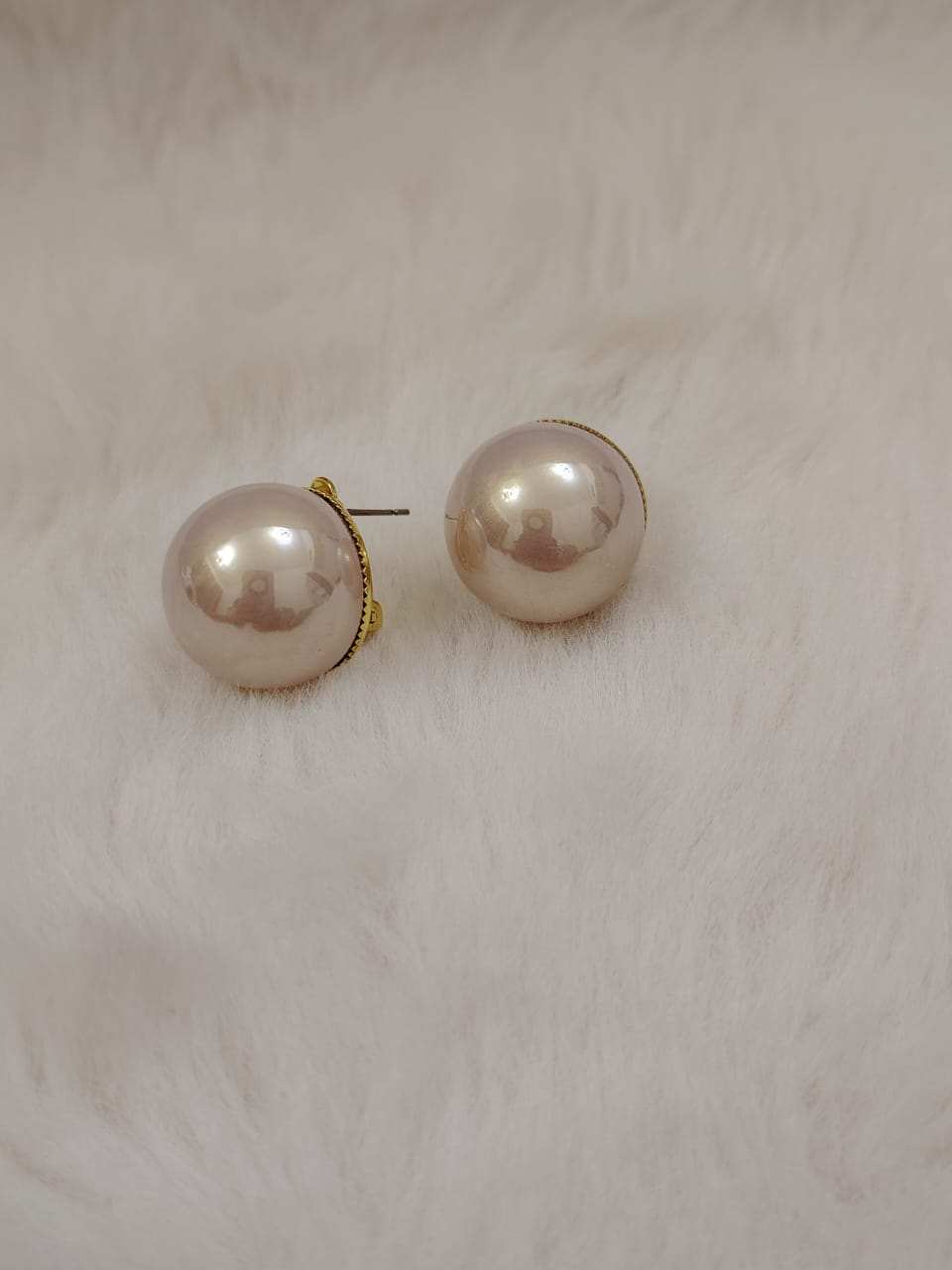 Oversized fresh water pearl studs in rosegold pearl.