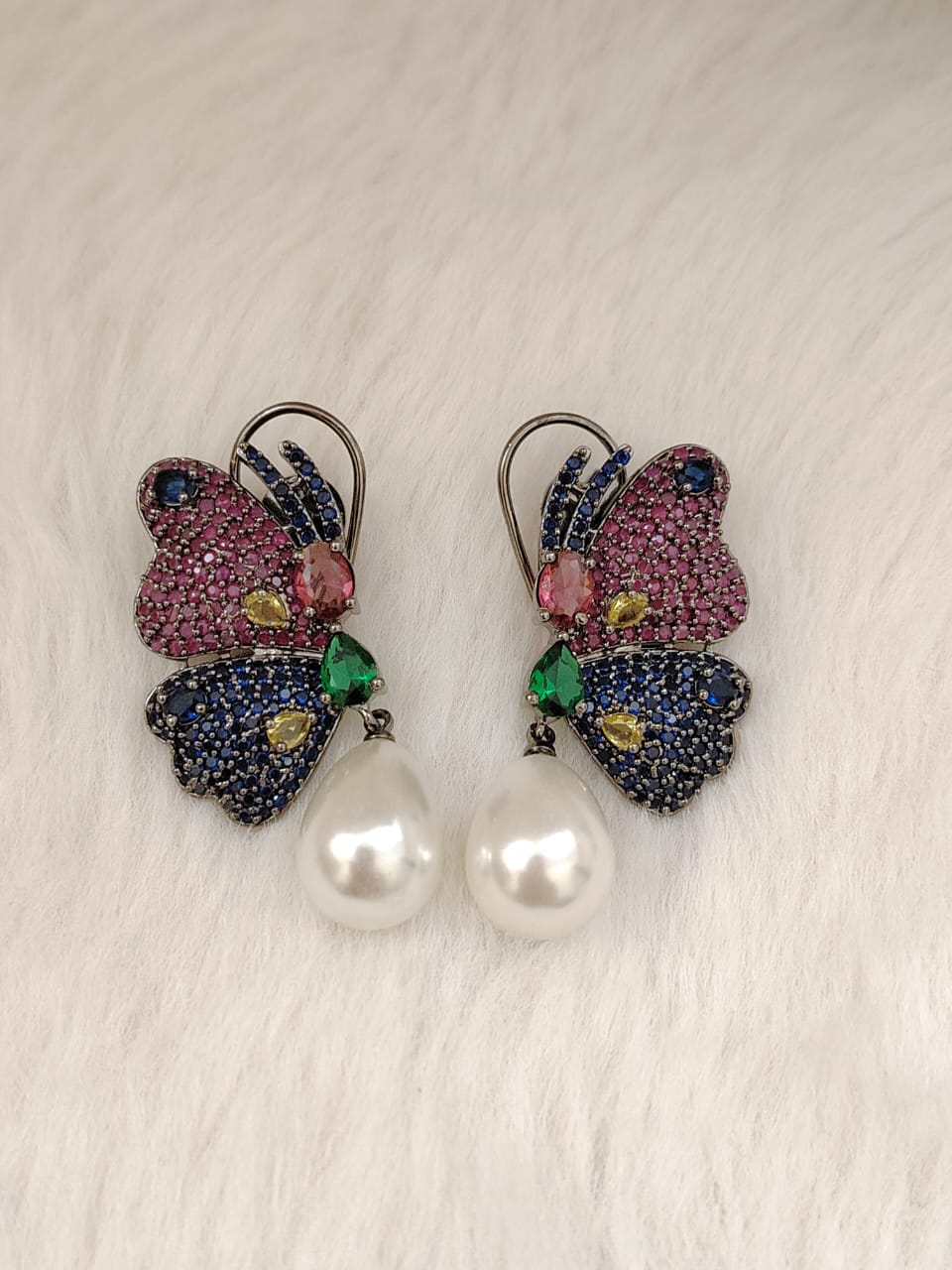 Beautiful butterfly earrings in blue and dark pink AD stones with pearl drops