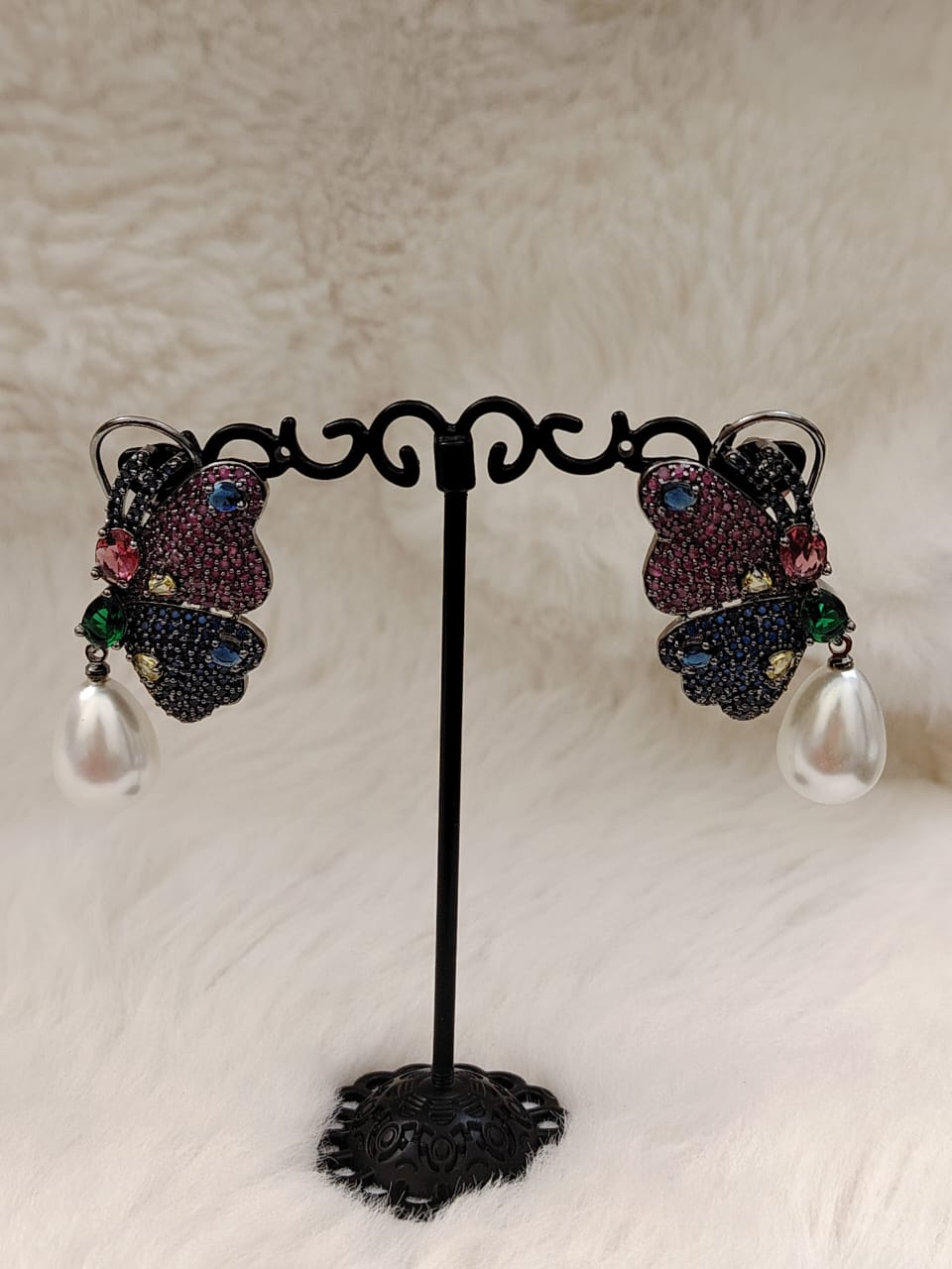 Beautiful butterfly earrings in blue and dark pink AD stones with pearl drops