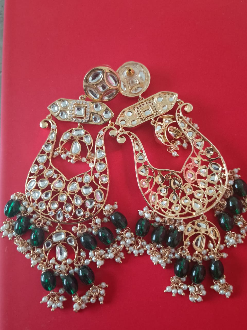 Big basket shaped chand bali with kundans, green awaze and pearls.