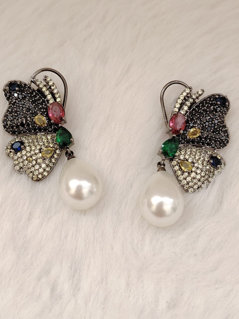 Beautiful butterfly earrings in blue and lime AD stones with pearl drops.