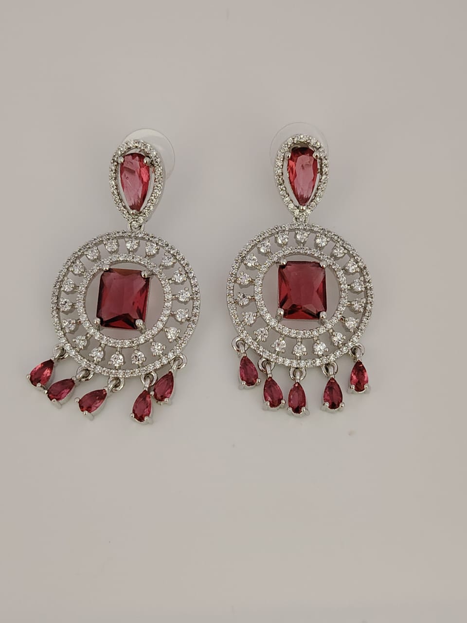 Silver tone statement earrings with red and white stones