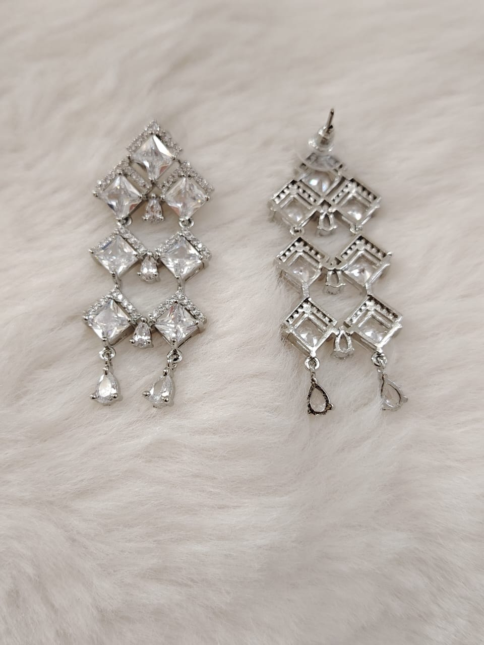 Silver danglers with american diamonds and cubic zirconia.