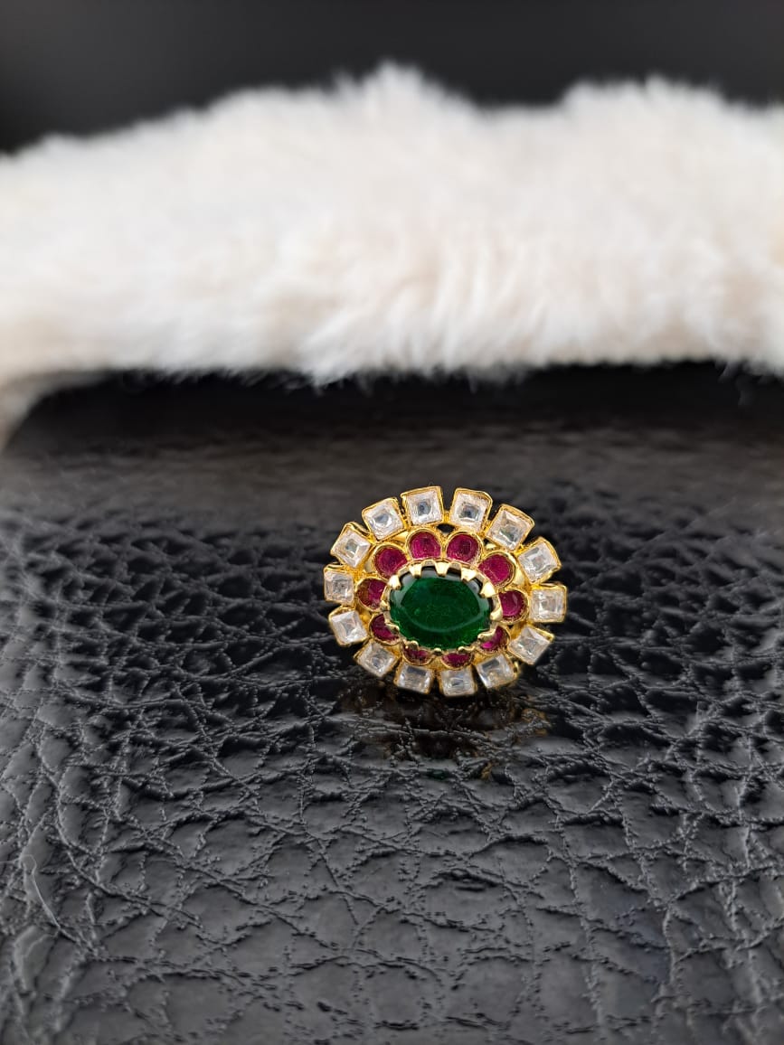 Pachi kundan finger ring with pink kemp stones and  emerald in center.