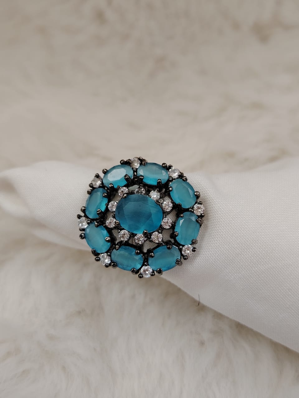 German silver oxidized finger ring with light blue and white zircons