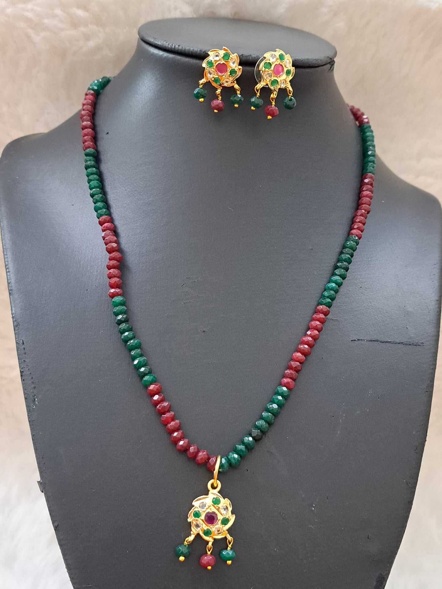 Real onyx beads set with ruby, emerald and polki kundans.