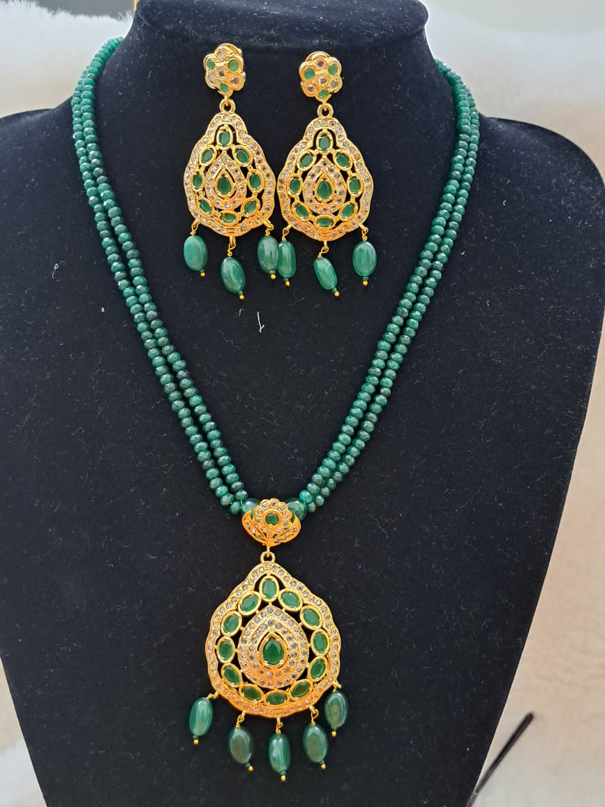 Hyderabadi pure onyx beads set with polki and emerald stones.