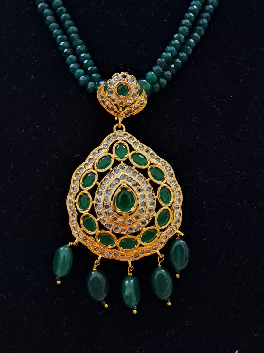 Hyderabadi pure onyx beads set with polki and emerald stones.