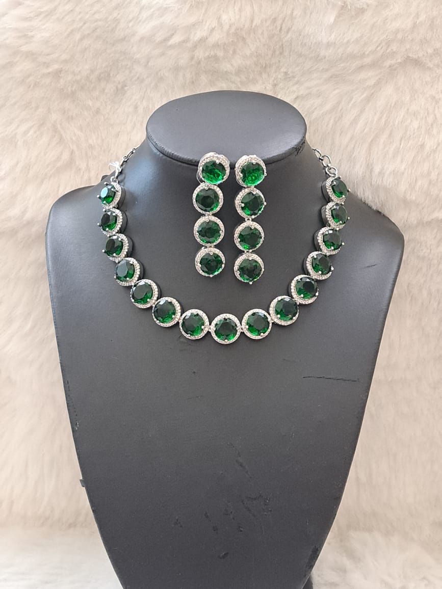 Gorgeous bottle green cubic zircon stones and american diamond set .