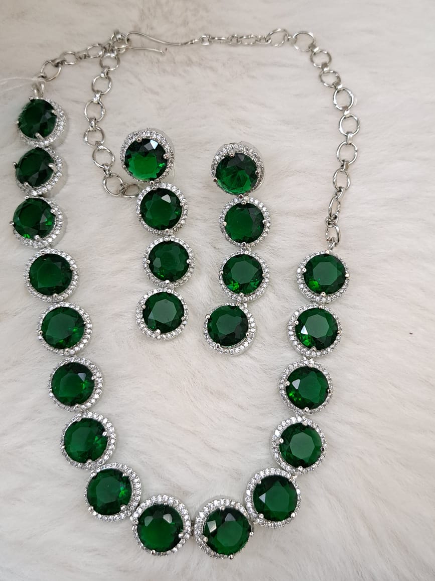 Gorgeous bottle green cubic zircon stones and american diamond set .