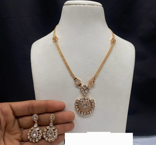 Gold pendant set with american diamonds
